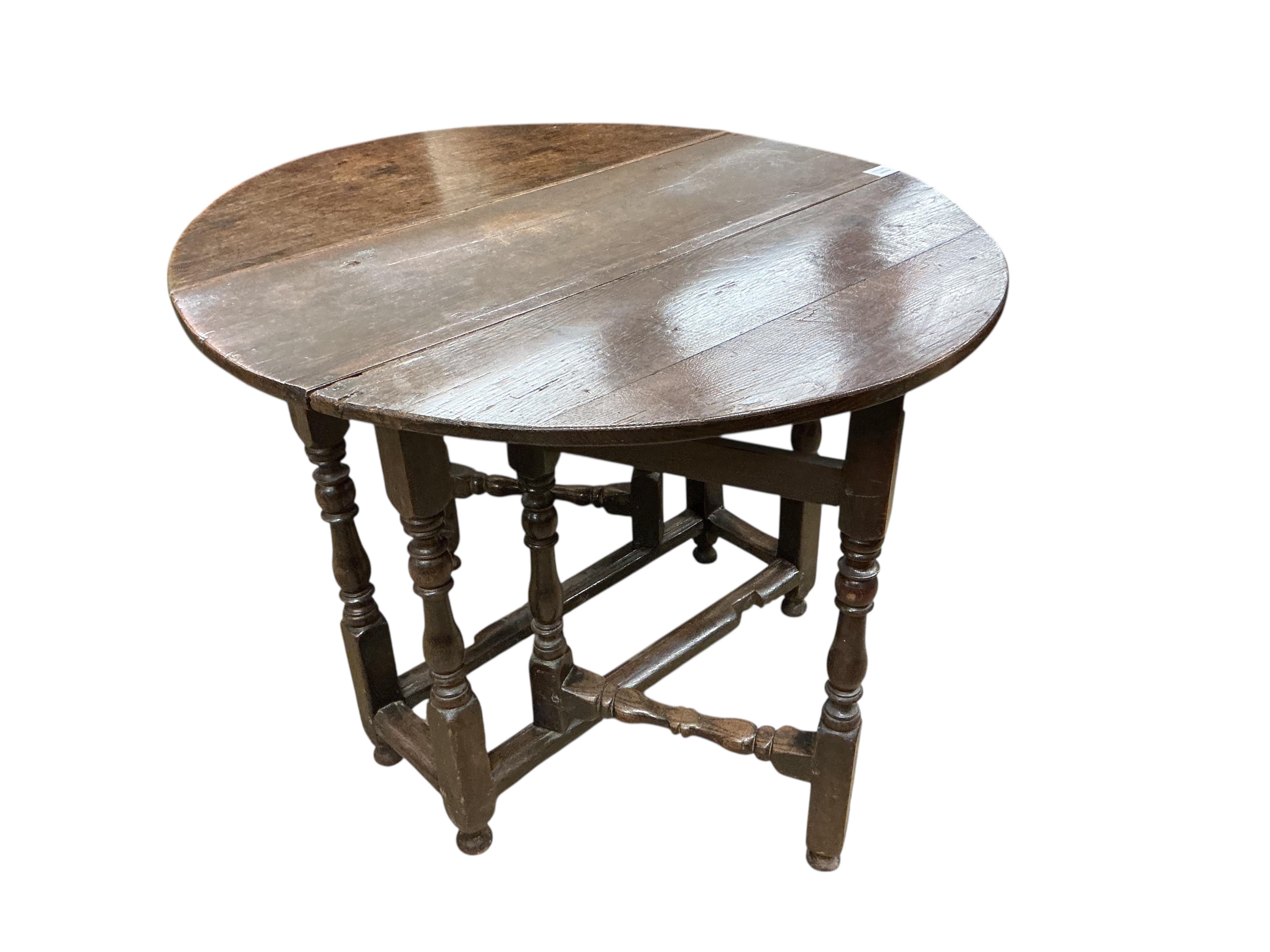 A small 18th century oval oak gate-legged table, width 92cm, depth 36cm, height 75cm